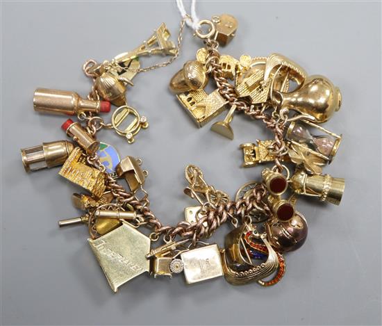 A 9ct charm bracelet hung with assorted charms, including bicycle, cathedral, cannon and minors lamp.